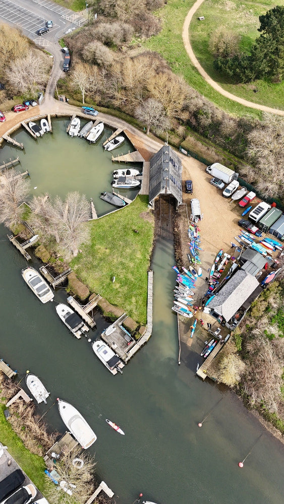 Aerial view of a marina with boats and a covered walkway.